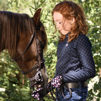 Young Woman interacting with a horsewearing SSG All Weather Pink Leopard print gloves.